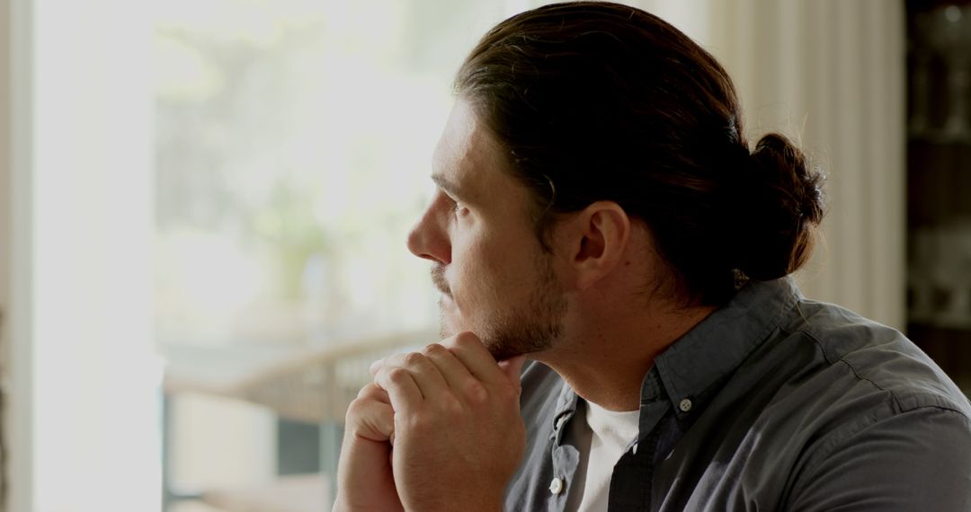 Man Writing in Notebook at Home Office with Laptop and Coffee