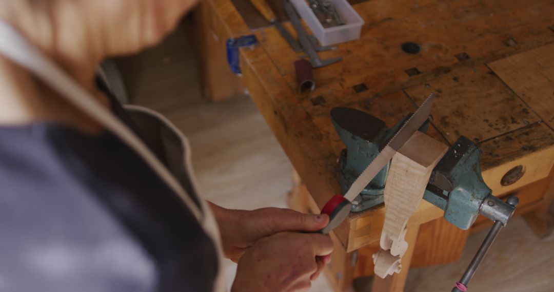 Person Using a File on Wood Block in Workshop - Free Images, Stock Photos and Pictures on Pikwizard.com