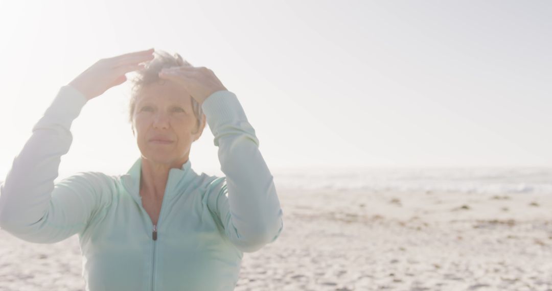 Senior Woman Practicing Qi Gong on Beach During Sunrise - Free Images, Stock Photos and Pictures on Pikwizard.com