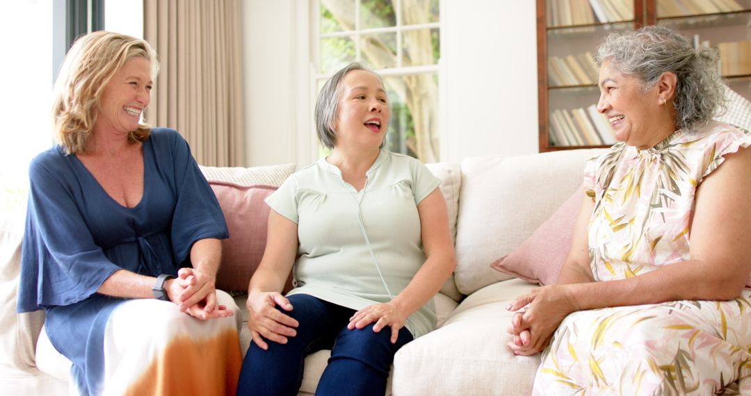 Senior Friends Group Enjoying Time Together Laughing on Sofa