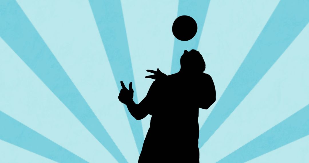 Silhouette of Football Player Juggling Ball Against Dynamic Background
