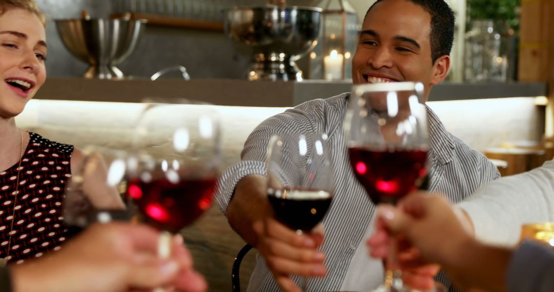 Friends Toasting With Red Wine in a Cozy Bistro - Free Images, Stock Photos and Pictures on Pikwizard.com