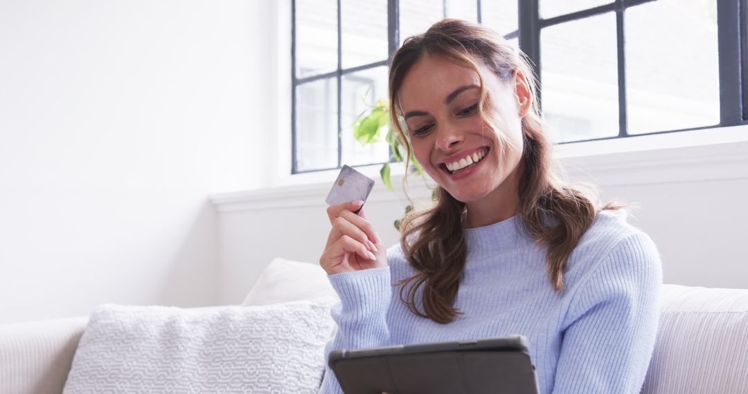 Joyful Woman Shopping Online with Tablet and Credit Card at Home