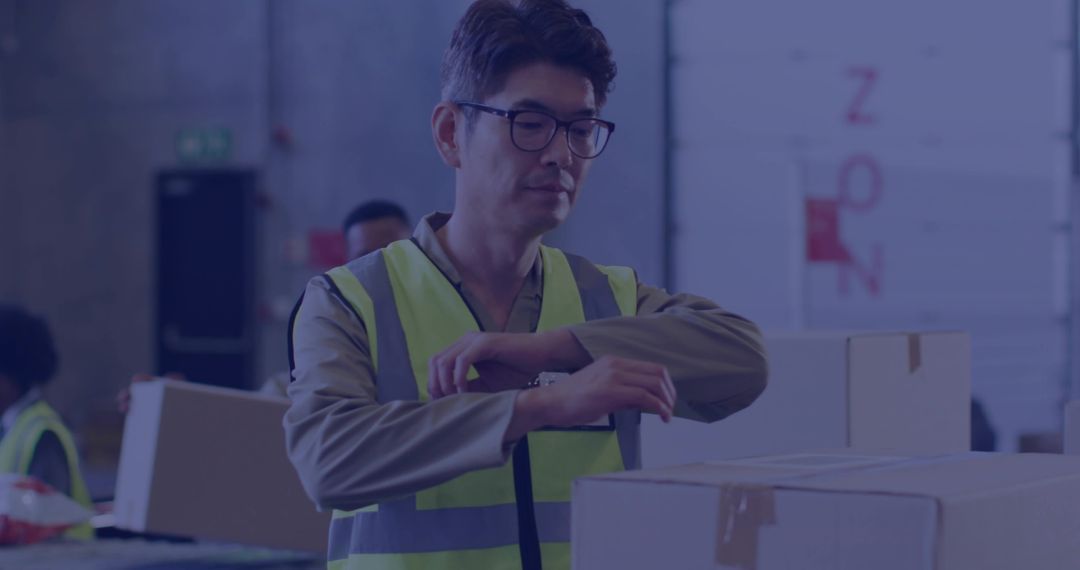 Inspecting Korean Warehouse Worker Checking Inventory and Handling Cardboard Boxes
