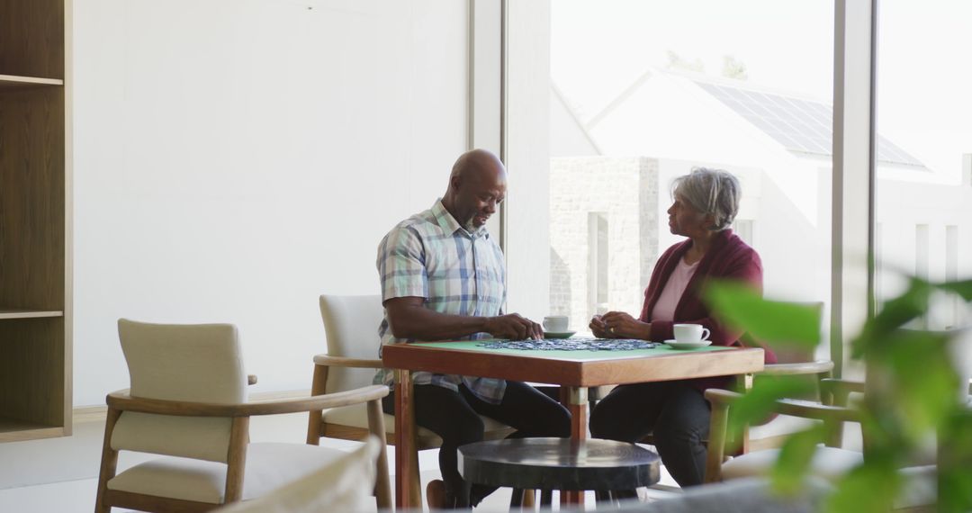 Senior Couple Enjoying Leisure Time Solving Puzzles Together