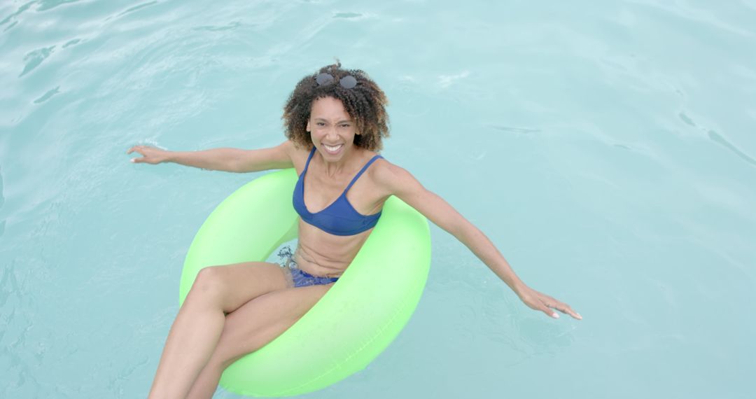Woman Relaxing on Pool Float in Sunny Summer Day