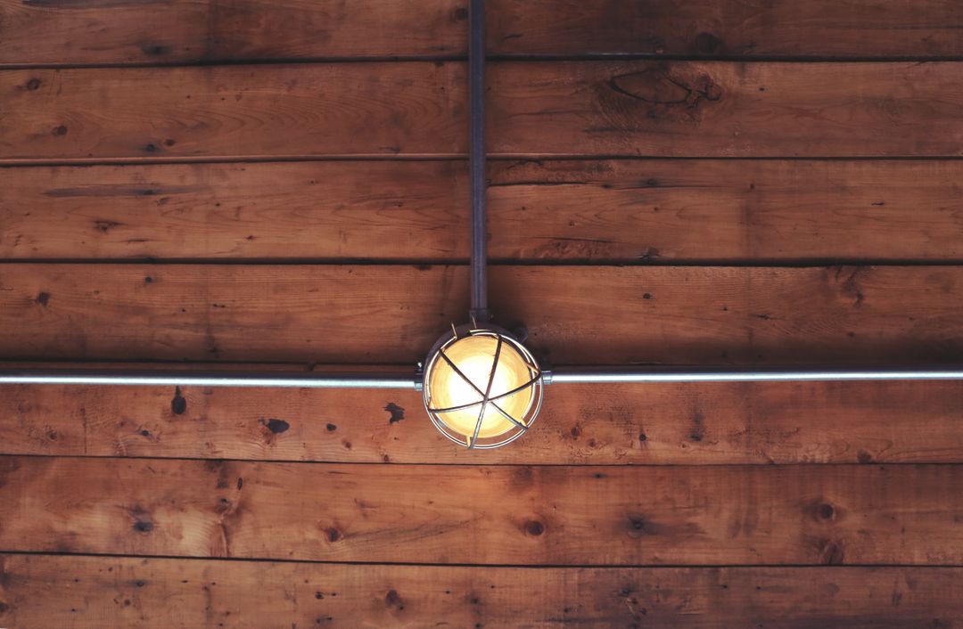 Vintage Industrial Light Fixture on Wooden Ceiling - Free Images, Stock Photos and Pictures on Pikwizard.com