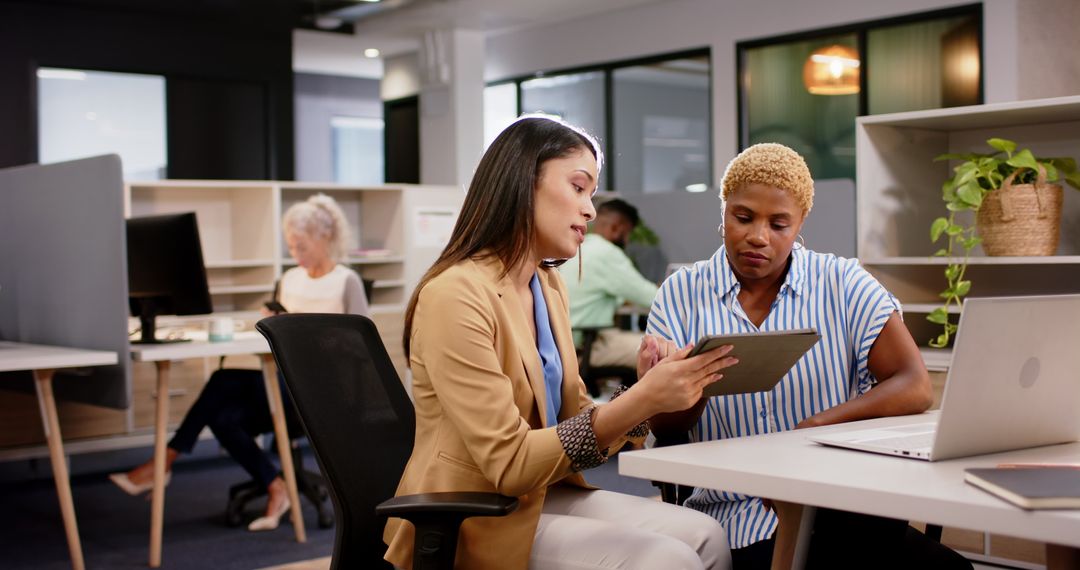 Businesswomen Using Tablet for Collaborative Project Discussion