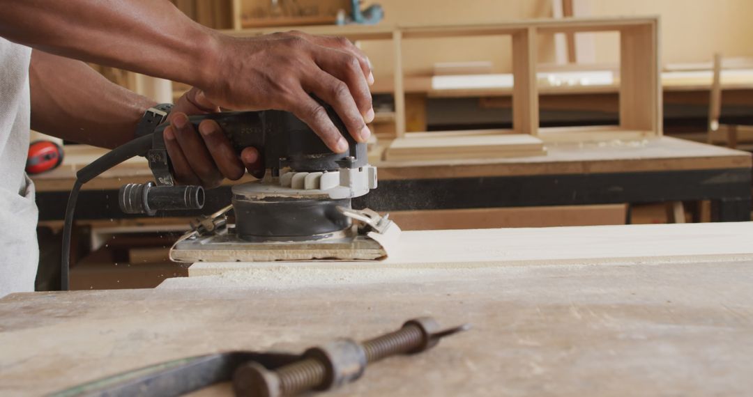 Close-Up of Man Using Electric Sander on Wood in Workshop - Free Images, Stock Photos and Pictures on Pikwizard.com