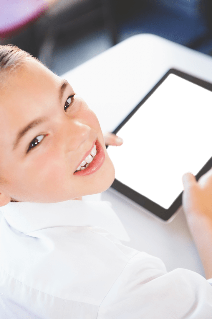 Smiling Girl Holding Transparent Tablet at Table