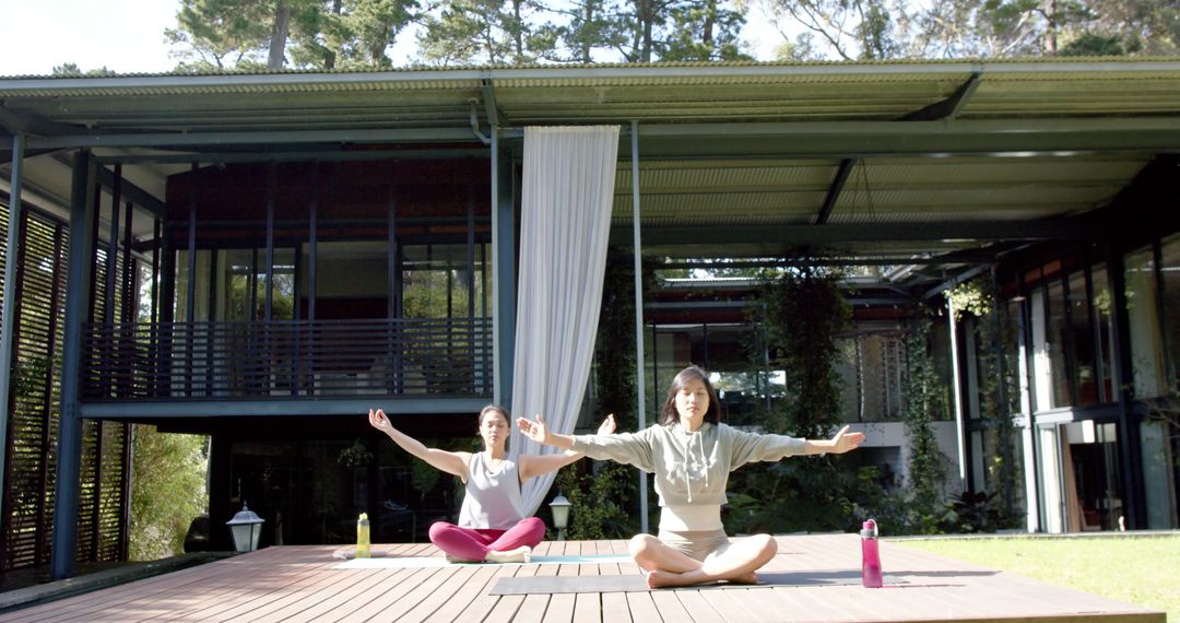 Two Women Doing Yoga Outdoors at Modern House - Free Images, Stock Photos and Pictures on Pikwizard.com