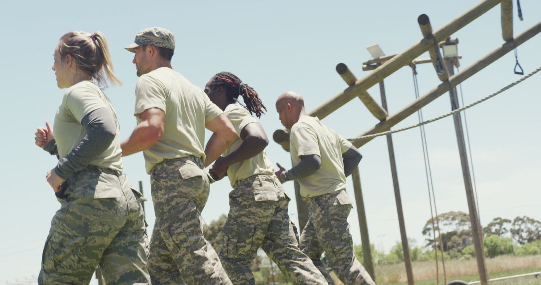 Soldiers Running on Obstacle Course Embracing Teamwork