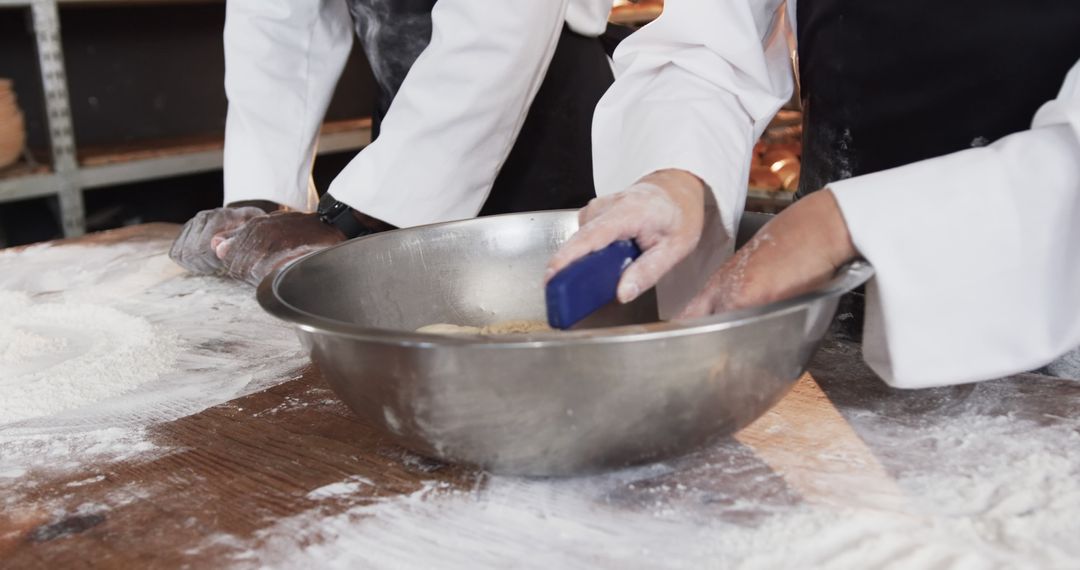 Bakers kneading dough in professional kitchen - Free Images, Stock Photos and Pictures on Pikwizard.com