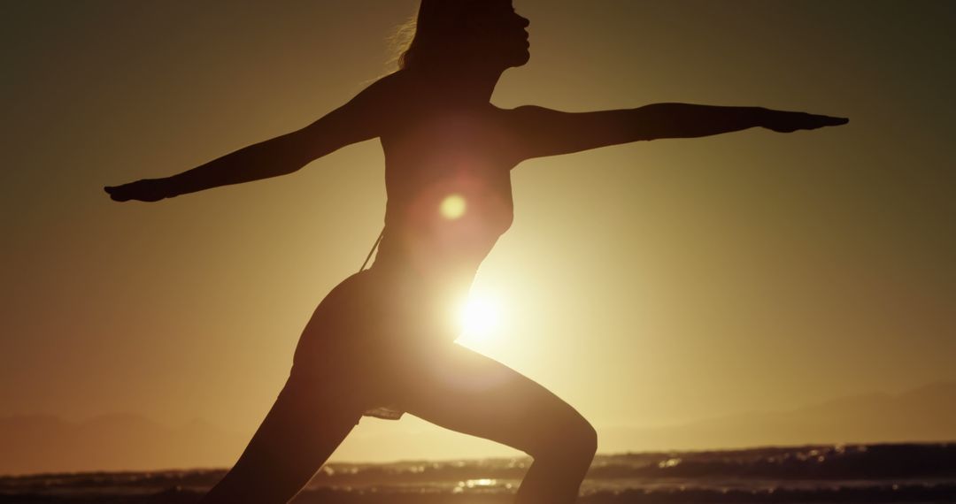 Silhouette of Woman Practicing Yoga on Beach at Sunset - Free Images, Stock Photos and Pictures on Pikwizard.com