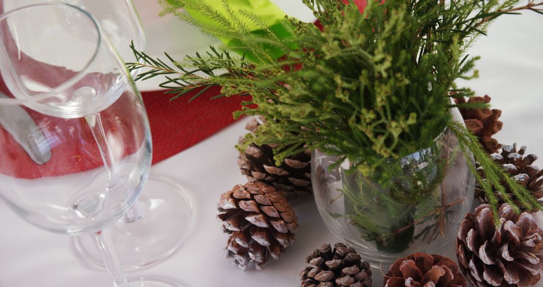 Festive Holiday Table Setting with Pinecones and Glassware - Free Images, Stock Photos and Pictures on Pikwizard.com