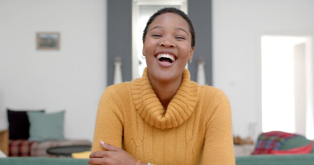 Cheerful Young Woman Smiling in Cozy Sweater at Home - Free Images, Stock Photos and Pictures on Pikwizard.com