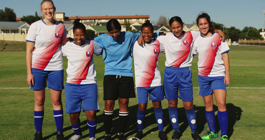 Smiling Female Soccer Team Posing for Group Photo on Green Field - Free Images, Stock Photos and Pictures on Pikwizard.com