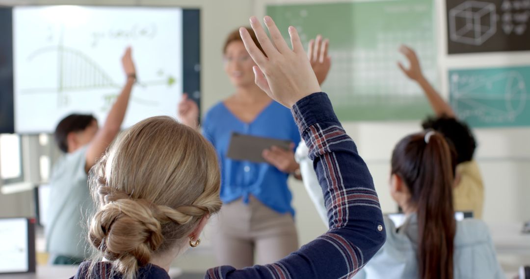 Students Engaged in Learning Environment with Raised Hands