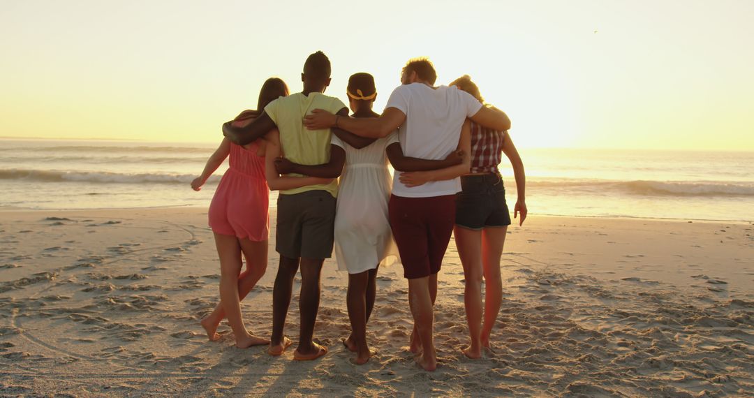 Group of Friends Embracing on Beach During Sunset - Free Images, Stock Photos and Pictures on Pikwizard.com