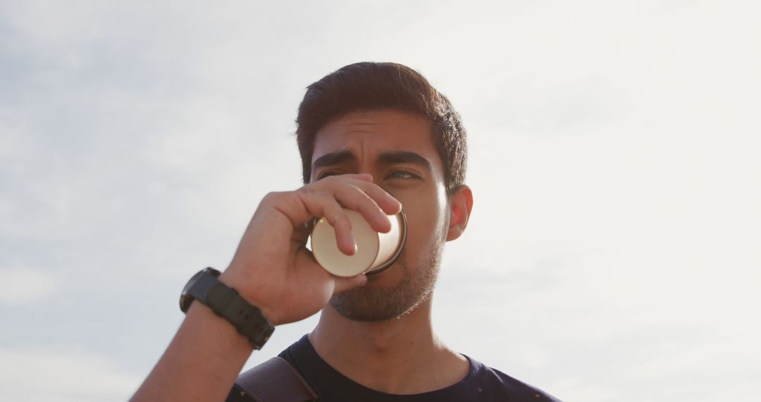 Young Man Drinking Coffee Outdoors During Sunrise - Free Images, Stock Photos and Pictures on Pikwizard.com