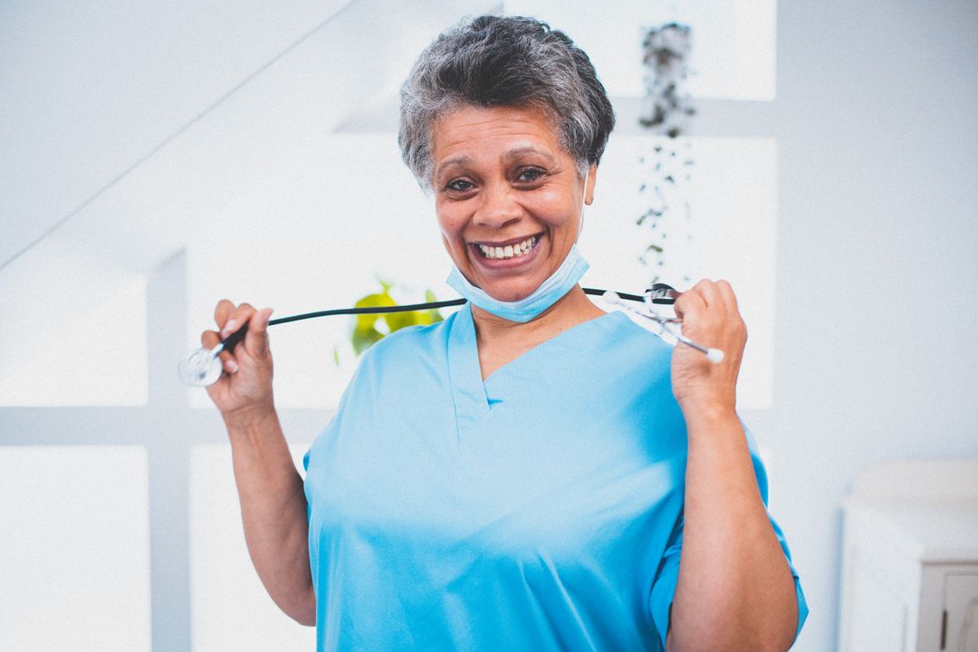 Portrait of african american female senior doctor wearing face mask smiling to camera - Free Images, Stock Photos and Pictures on Pikwizard.com