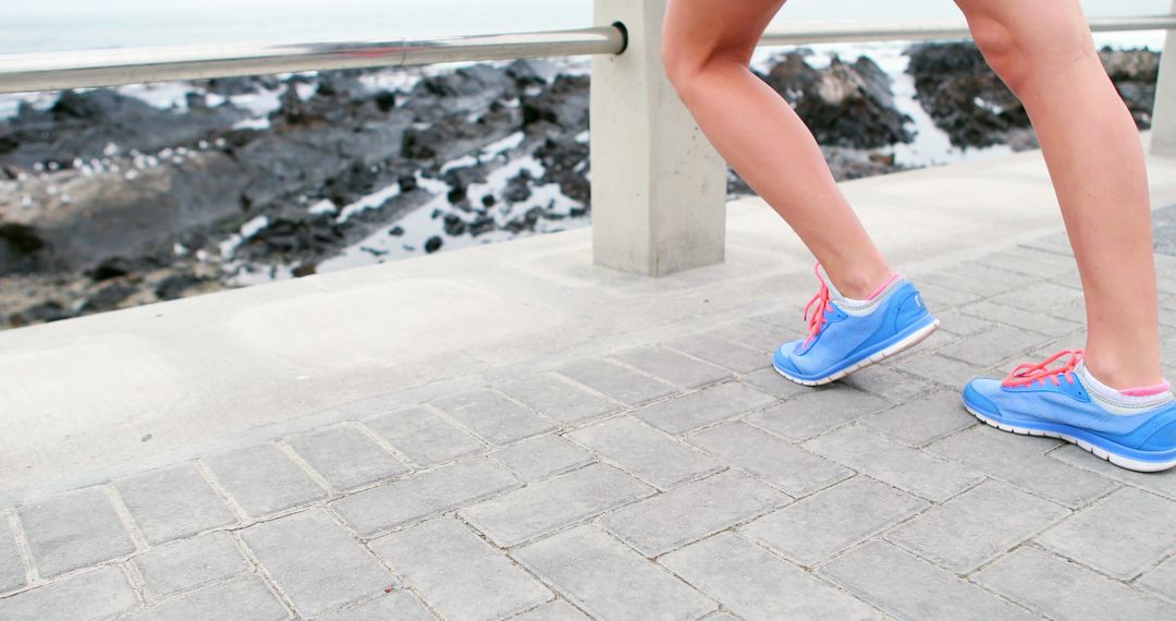 Woman Jogging Along Seaside Overlook with Blue Running Shoes - Free Images, Stock Photos and Pictures on Pikwizard.com