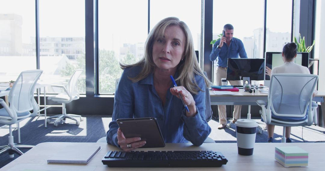 Confident Businesswoman Using Tablet in Modern Open Workspace