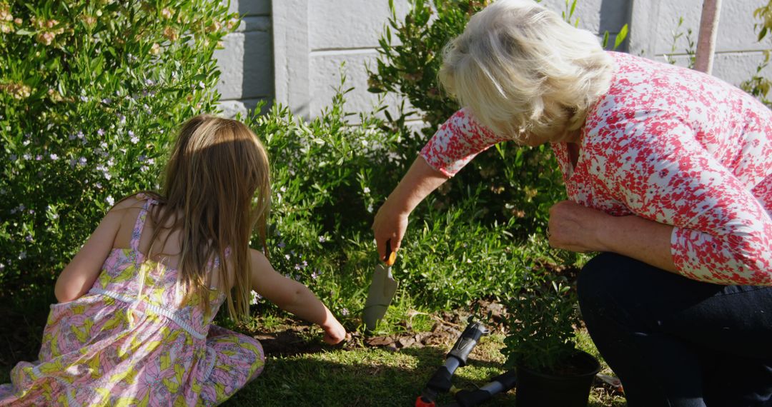 Grandmother and Granddaughter Gardening Together in Blooming Yard - Free Images, Stock Photos and Pictures on Pikwizard.com