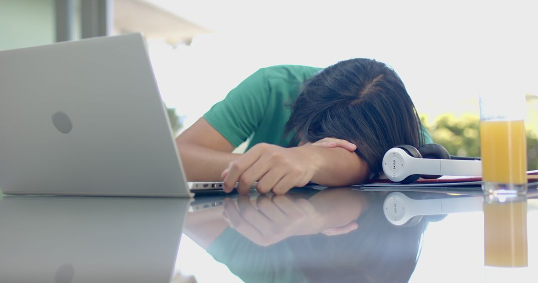 Exhausted Student Resting at Study Desk with Laptop in Slow Motion
