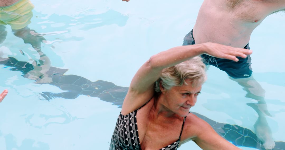 Elderly woman participating in water aerobics - Free Images, Stock Photos and Pictures on Pikwizard.com