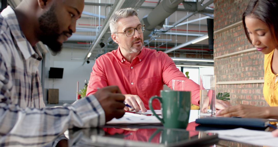 Multiracial Team Engaged in Active Discussion in Modern Office