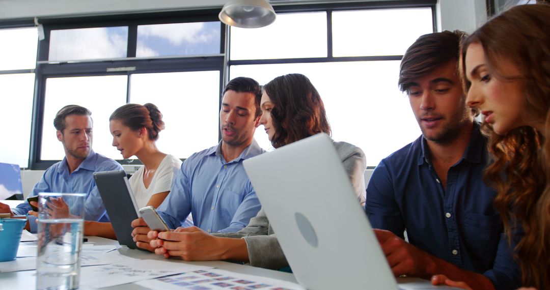 Team Collaboration in Modern Office Setting with Digital Devices