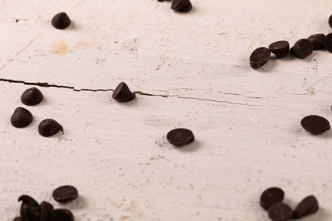Close-up of chocolate chips on white table, copy space - Free Images, Stock Photos and Pictures on Pikwizard.com