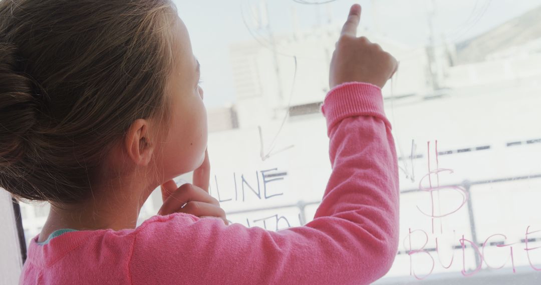 Young Girl Writing on Glass with Dry Erase Marker - Free Images, Stock Photos and Pictures on Pikwizard.com