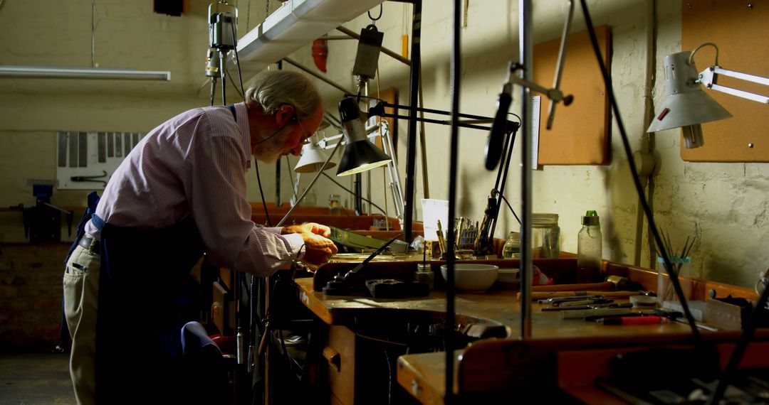 Elderly Man Working in a Workshop - Free Images, Stock Photos and Pictures on Pikwizard.com