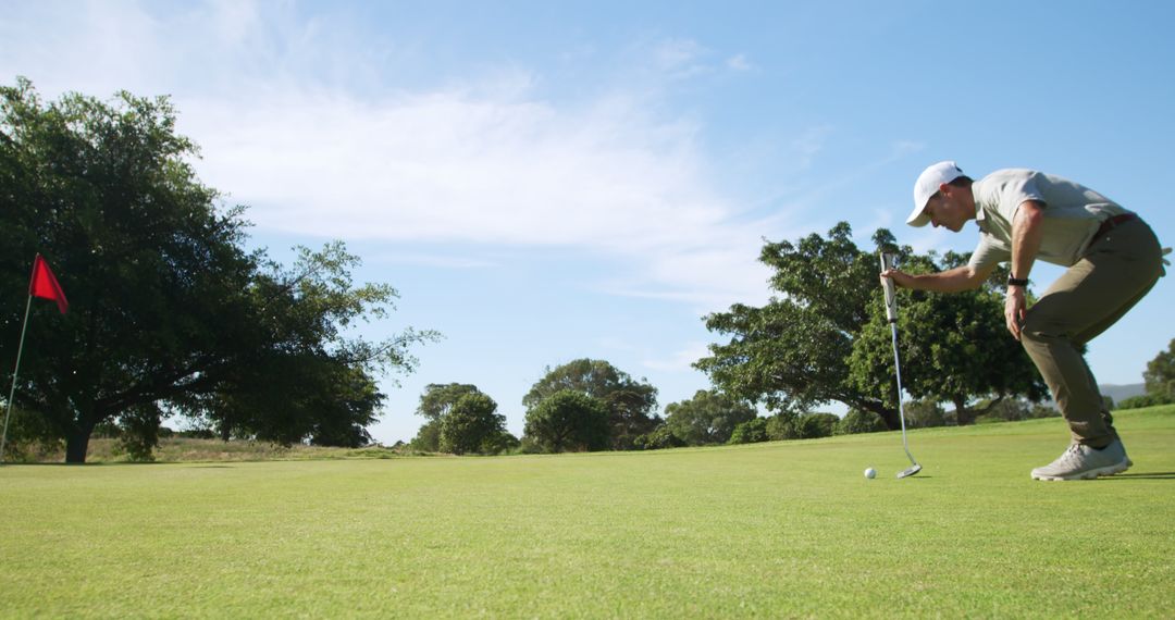 Golfer Strategically Aligning Shot for Perfect Putt