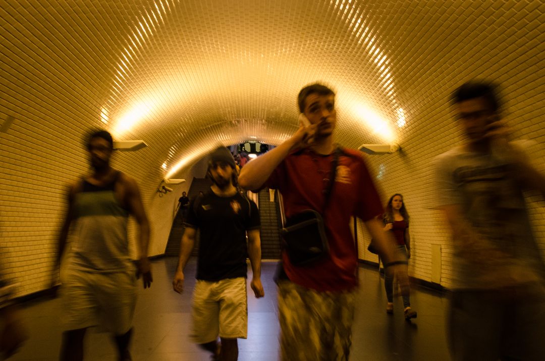 Group of Young Men Walking Through Dimly Lit Tunnel - Free Images, Stock Photos and Pictures on Pikwizard.com