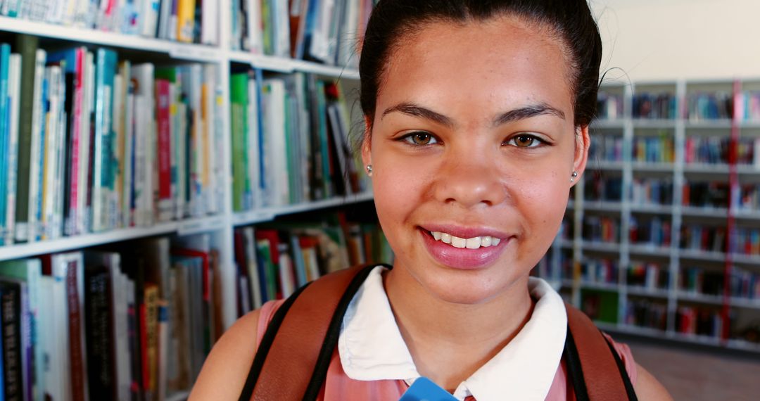 Smiling Student Holding Book in Library - Free Images, Stock Photos and Pictures on Pikwizard.com