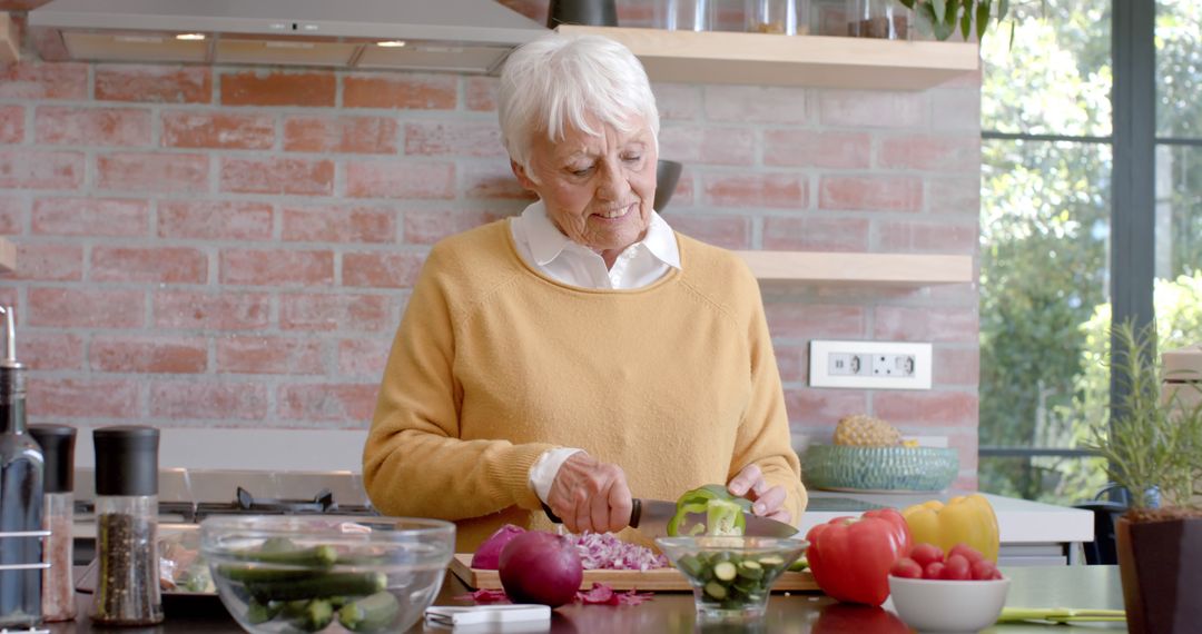 Elderly Woman Cooking Vegetables in Modern Kitchen - Free Images, Stock Photos and Pictures on Pikwizard.com