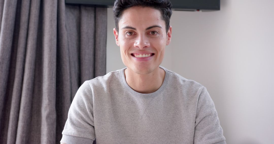 Smiling Young Man Engaging in Video Call at Home