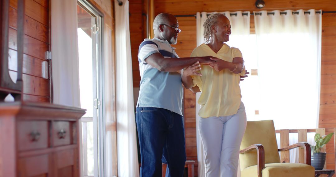 Elderly Couple Enjoying Happy Moment Dancing at Home - Free Images, Stock Photos and Pictures on Pikwizard.com