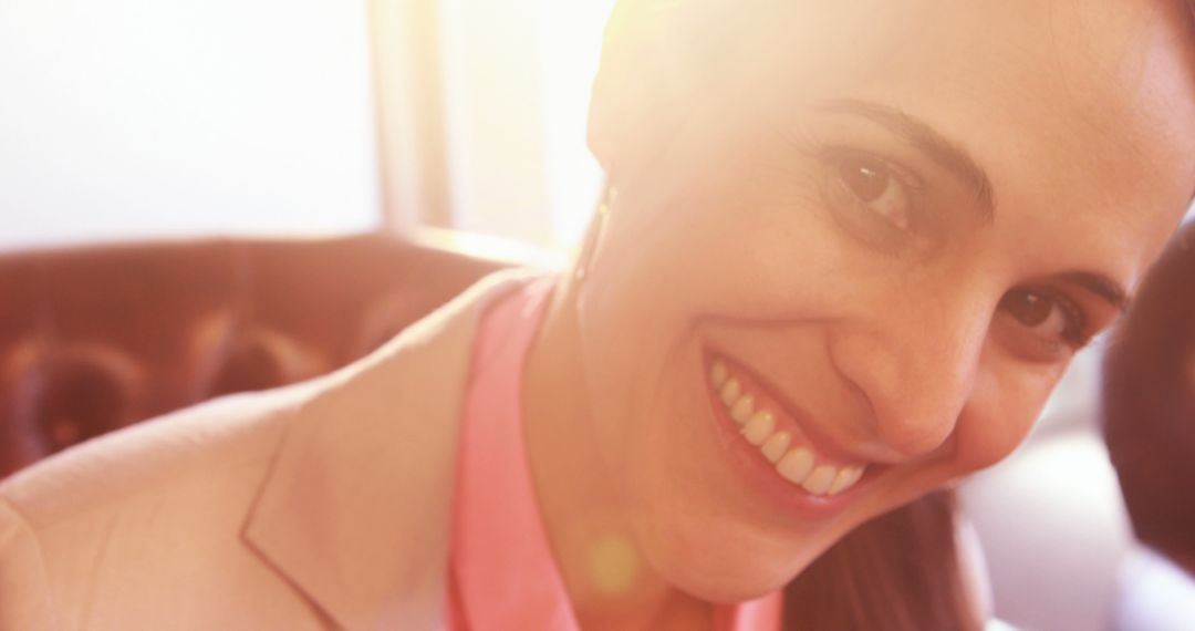 Smiling Woman in Blazer with Sun Flare - Free Images, Stock Photos and Pictures on Pikwizard.com