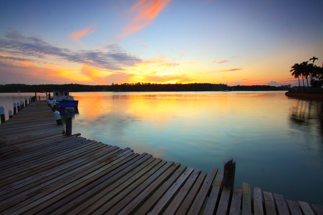 Serene Sunset Over Tranquil Lake with Wooden Dock - Free Images, Stock Photos and Pictures on Pikwizard.com