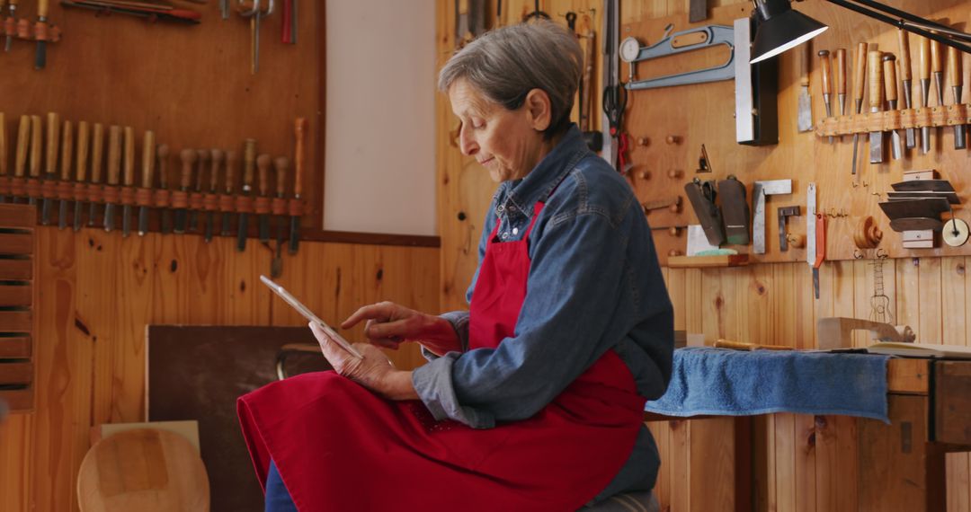 Senior Female Woodworker Using Digital Tablet in Workshop - Free Images, Stock Photos and Pictures on Pikwizard.com