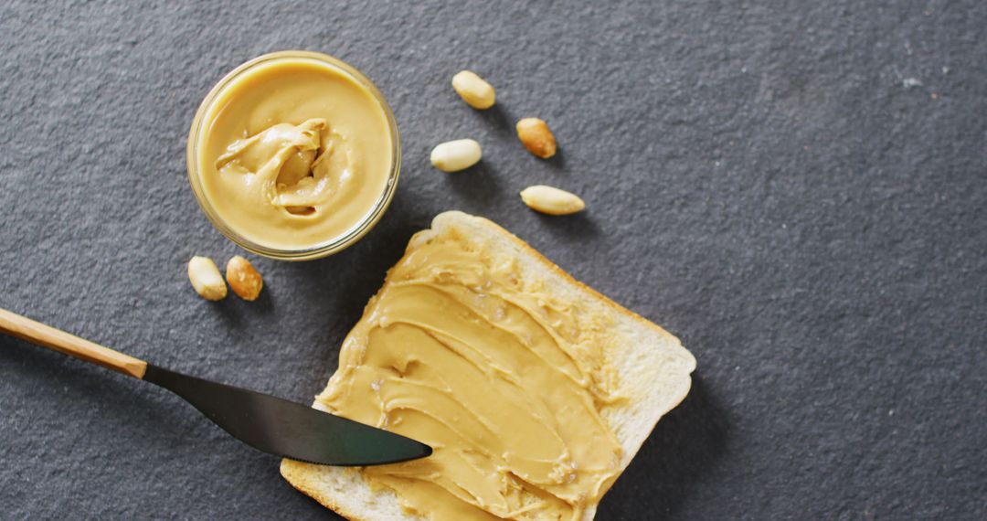Creamy Peanut Butter Spread on Toast with Peanuts