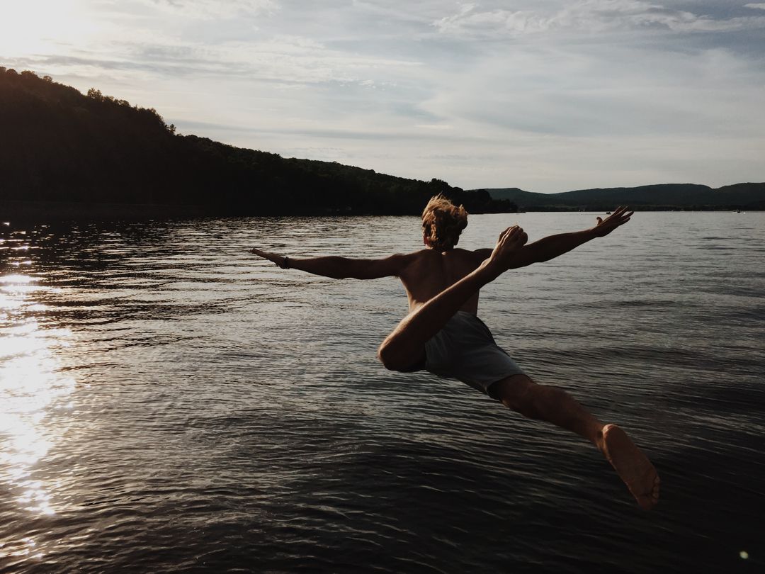 Man Leaping Into Lake at Sunset - Free Images, Stock Photos and Pictures on Pikwizard.com