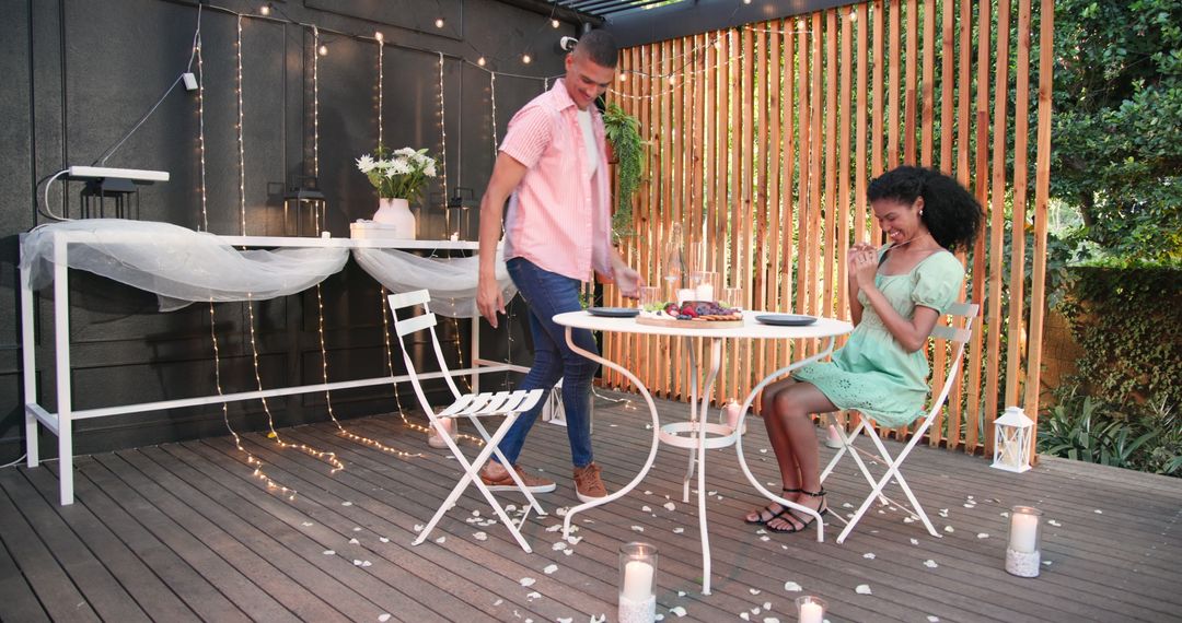 Romantic Candlelit Dinner Outdoors with Diverse Couple Seated at Table