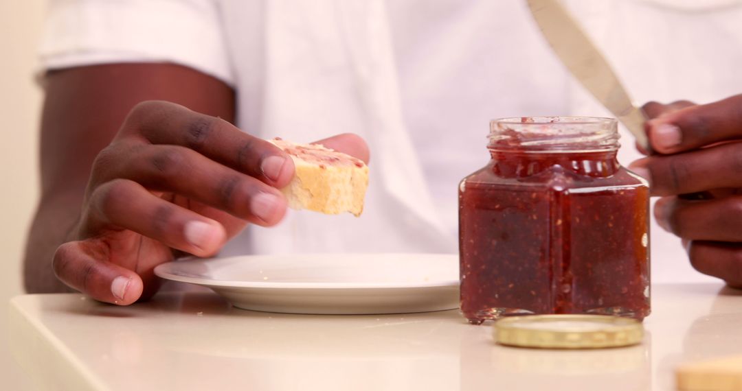 Person Spreading Jam on Toast at Breakfast Table - Free Images, Stock Photos and Pictures on Pikwizard.com