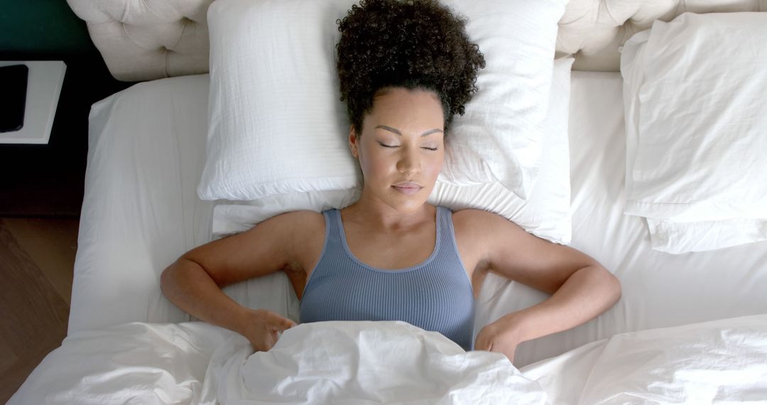 Biracial Woman Sleeping Peacefully in Cozy Bed - Free Images, Stock Photos and Pictures on Pikwizard.com