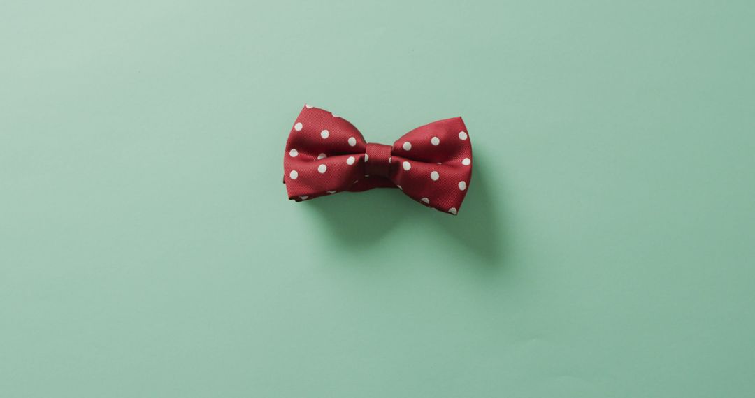 Red Polka Dot Bow Tie on Green Background - Free Images, Stock Photos and Pictures on Pikwizard.com